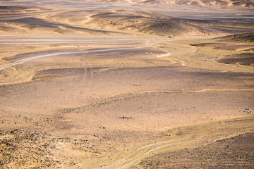 Fototapeta premium Volcanic black basalt terrain in Sahara desert in Morocco