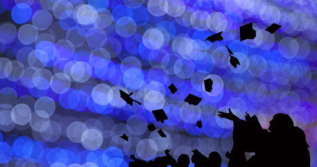 Silhouette of Graduate Students throw mortarboards in university graduation success ceremony....
