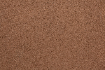 Brown painted stucco wall.