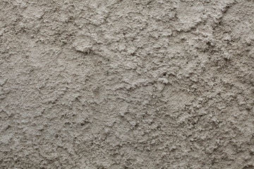 Rough unpainted concrete wall.