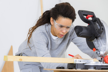 female carpenter marking the wood
