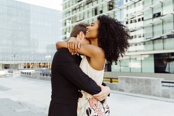 Young couple hugging on street