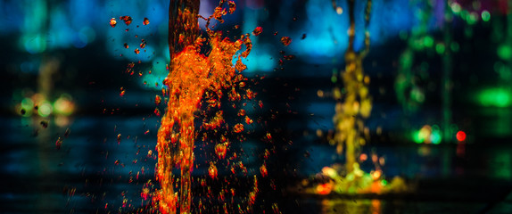 VOLCANO - Colorful fountain in the night city landscape
