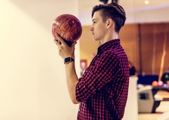 Boy about to roll a bowling ball hobby and leisure concept