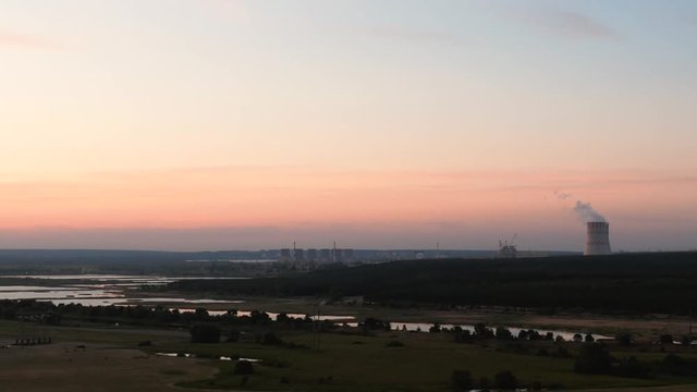 Natural landscape with NPP or Nuclear Power Plant after sunset.
