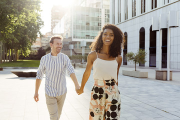 Cheerful couple walking on street