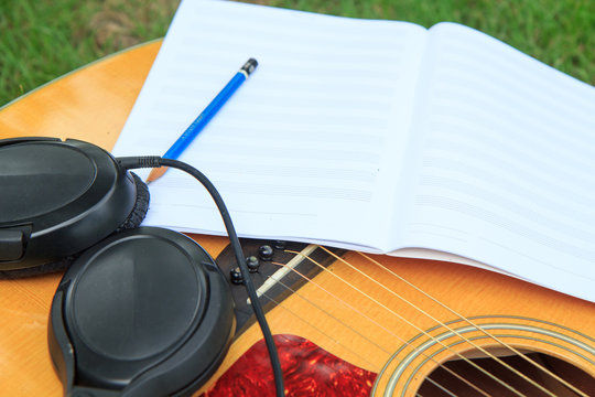 staff book for write note of song with use acoustic guitar for play