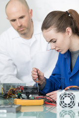 engineering student working on circuit with teacher