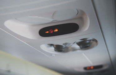 Interior inside of the plane. Smoking not allowed sign.