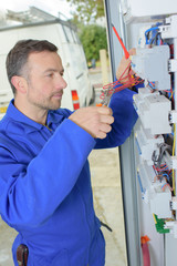 electrician mending an electrical panel