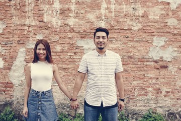 Asian couple holding hands together