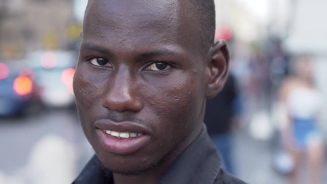 Handsome young black amrican man turning and looking at camera- close up