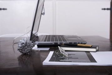 Workplace with laptop and on the table histograms and financial flows