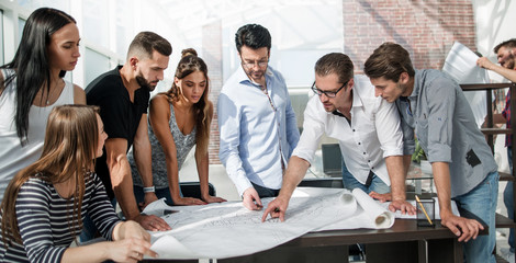 businessman discussing with the design team new sketches