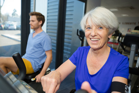mature man and senior woman in fitness club