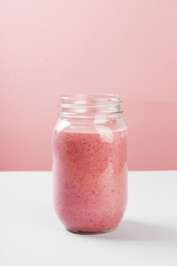 Strawberry smoothies on a pink background