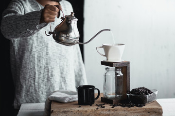 Fototapeta na wymiar Coffee drip,Hand holding a kettle Drip Coffee In the room 