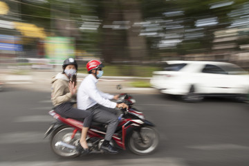 People on scooters during the TET holiday in downtown Ho Chi Minh City, Vietnam 2016.