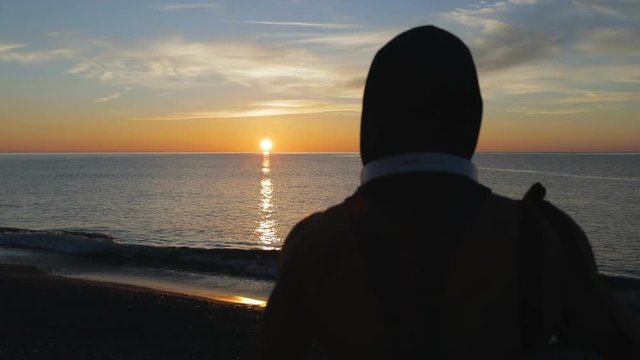Silhouette di un ragazzo si sta allenando di fronte l'Oceano o il mare all'alba di mattina presto.