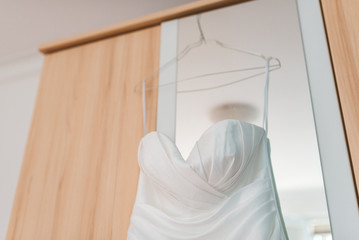 Wedding dress on a hanger in the bride's room