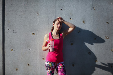 tired resting sports woman almost knockout after workout drinking a healthy shake from a bottle...