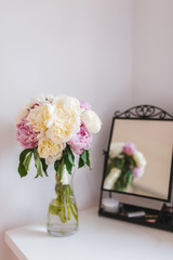 Bouquet made of white and pink Paeonia flowers and a mirror.