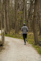 Obraz premium Jogging on a trail path in a forest