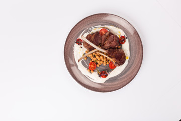 Front and Top view isolated - Lamb chops with tomato sauce sauce.