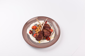 Front and Top view isolated - Lamb chops with tomato sauce sauce.