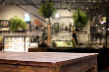 Selected focus empty brown wooden table and Coffee shop or restaurant blur background with bokeh image. for your photomontage or product display