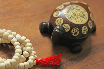 Buddhist beads. Rosary or beads from the sacred tree of Tulasi with a red tassel and a Chinese...