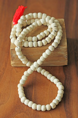 Buddhist beads. Rosary or beads from the sacred tree of Tulasi with a red tassel