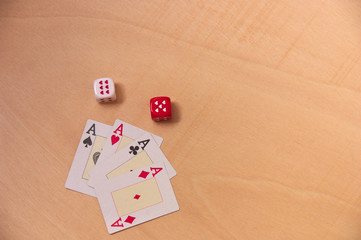 Cards with four aces and two dice with red and white hearts