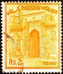 Old building on vintage postage stamp of Pakistan