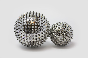 Eastern medicine. Set for su-Jok massage ball and magnetic ring on a white background. Massage of the hands and feet