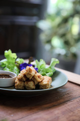 Vegan food appetizer japanese fried tofu on wood background vintage style