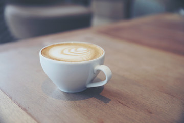 cappuccino or Latte art coffee made from milk on the wood table in coffee shop