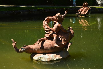 Sculpture In A Fountain With Little Angels Up On Top Of Fishes That Emanate Water In The Gardens Of The Farm. Art History Biology. June 19, 2018. La Granja Segovia Spain.