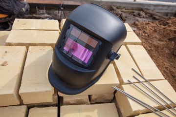 Fototapeta na wymiar A helmet for welding metal on the building site