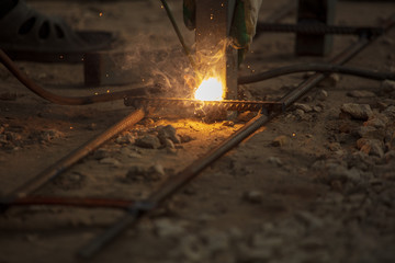 Worker welds metal at the construction site