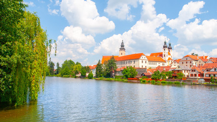 Fototapeta premium Telc Panorama. Water reflection of houses and Telc Castle, Czech Republic. UNESCO World Heritage Site.