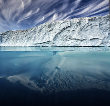 glacier with above and underwater view taken in greenland.