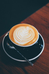 Fototapeta na wymiar barista make coffee latte art with coffee espresso machine in coffee shop cafe in vintage color tone