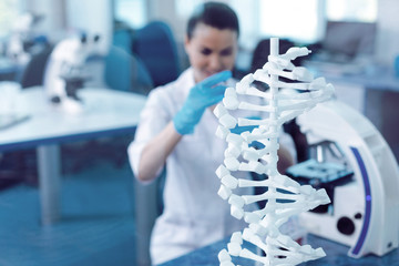 Modern genetics. Selective focus of a DNA model standing on the table in the genetic laboratory