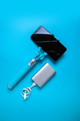 Set for photographing and traveling monopods with smartphone for selfie and power bank. Stick with smartphone isolated