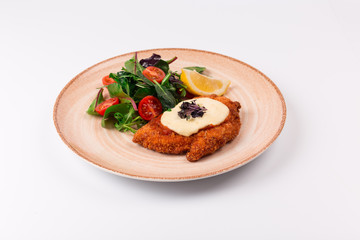 Top and front view isolated - Chicken parmesan cheese and mixed salad.
