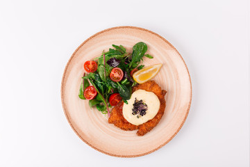 Top and front view isolated - Chicken parmesan cheese and mixed salad.