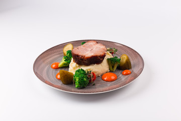 Front and top view isolated - The slow cook recipe with chilli pepper, mashed potatoes, broccoli and pickled cucumber.