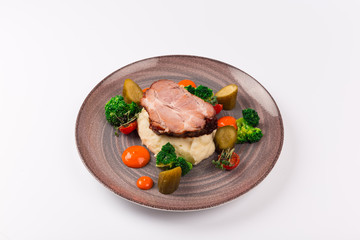 Front and top view isolated - The slow cook recipe with chilli pepper, mashed potatoes, broccoli and pickled cucumber.