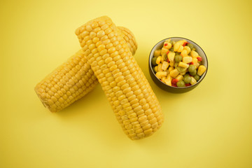 Boiled corn stock images. Corn salad in a bowl. Corn on the cob stock images. Yellow maize stock images. Two corn cobs on a yellow background